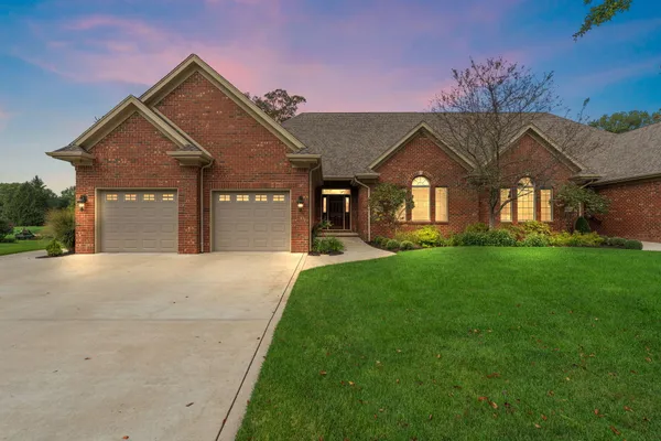 a front view of a house with a yard and garage