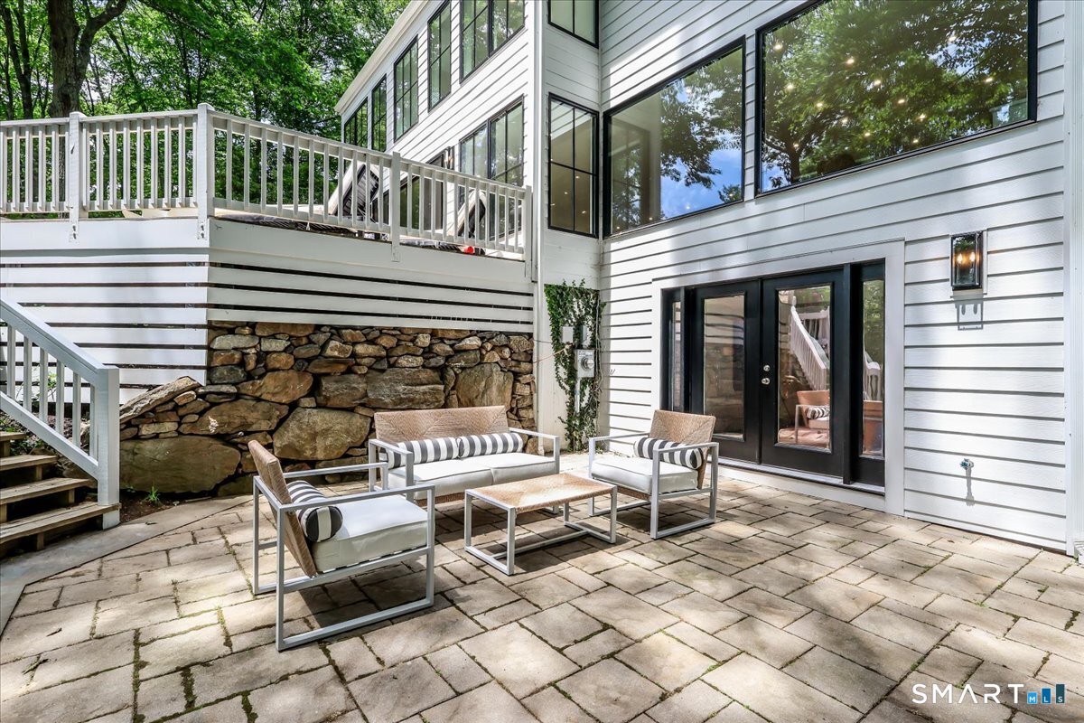 256 Wilton Road East Ridgefield, CT 06877 - Photo 36 of 40 a wooden bench sitting in front of a building
