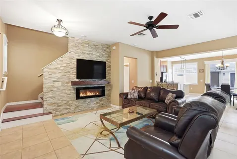a living room with a fireplace and a flat screen tv