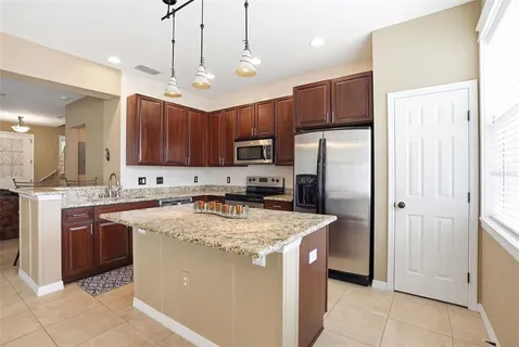 a large kitchen with a table and chairs