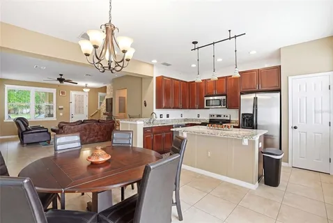 a kitchen with granite countertop sink dining table and chairs