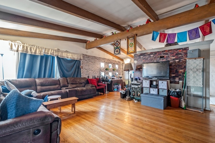 8645 Frontage Road Skokie, IL 60077 - Photo 2 of 13 a living room with furniture and a flat screen tv