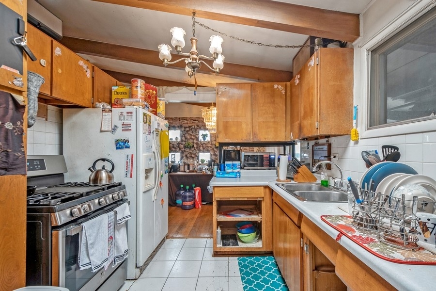 8645 Frontage Road Skokie, IL 60077 - Photo 4 of 13 a kitchen with stainless steel appliances granite countertop a stove and a sink