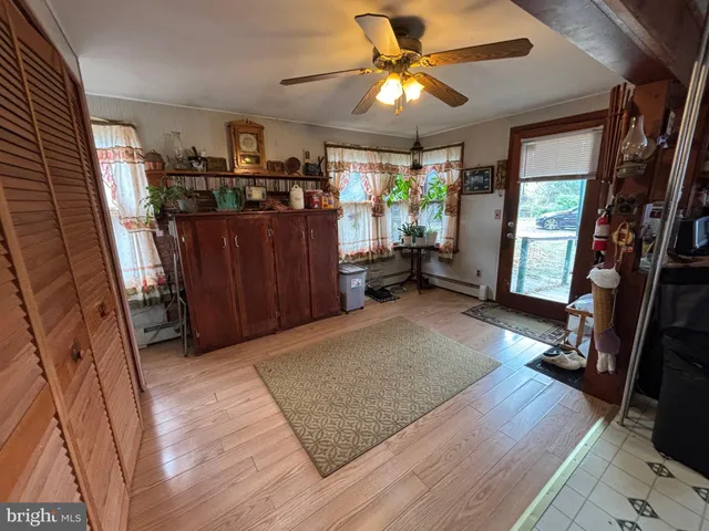 a view of a livingroom with furniture and a ceiling fan