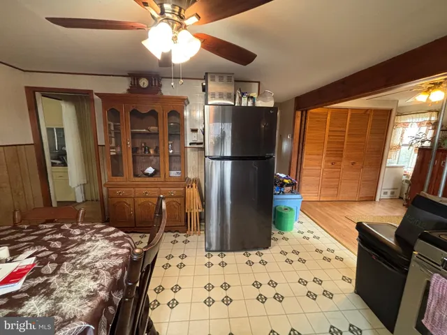 a kitchen with a refrigerator and a stove top oven