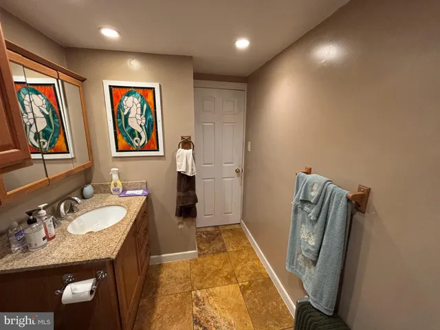a bathroom with double vanity sink and a mirror