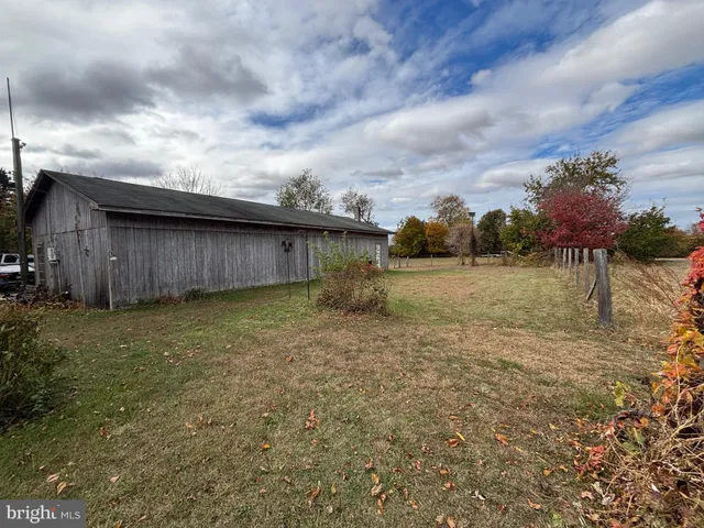 a backyard of a house with a yard and outdoor seating