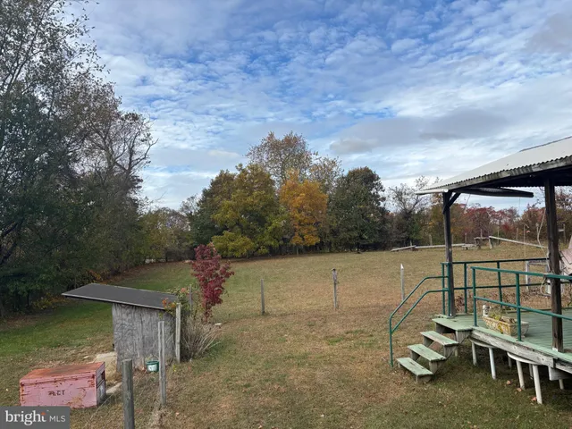 a view of a lake with a table and chair under an umbrella