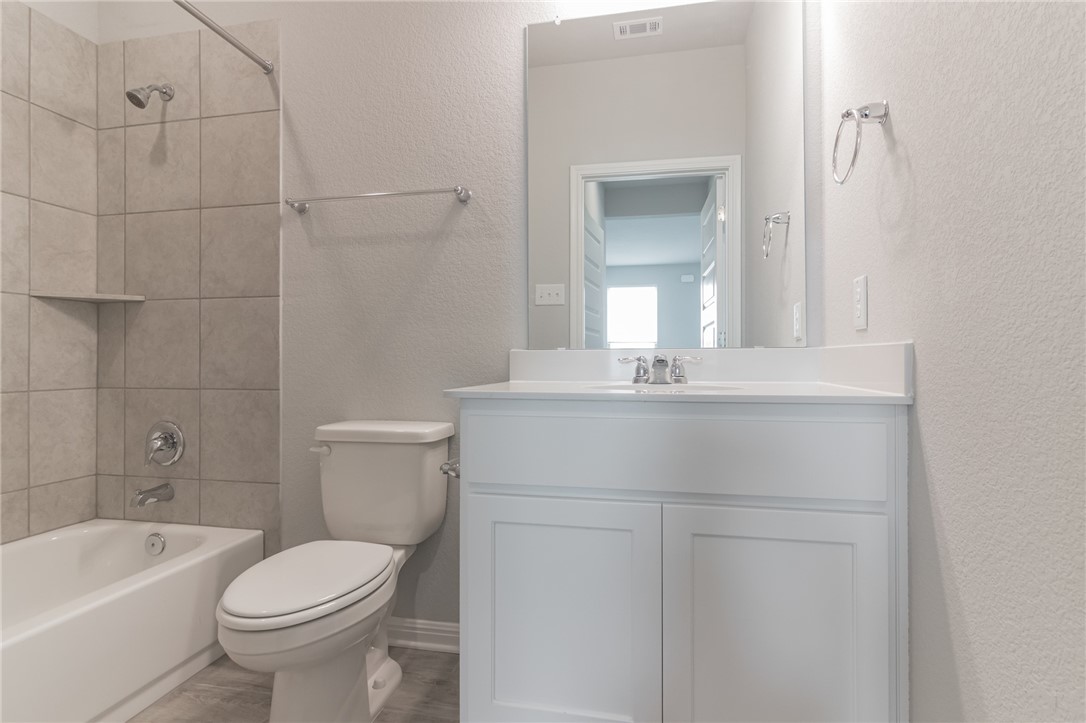 129 Wild Wind Trail Jarrell, TX 76537 - Photo 14 of 27 MIL bathroom next to MIL bedroom. Another one of the 4 full bathrooms.