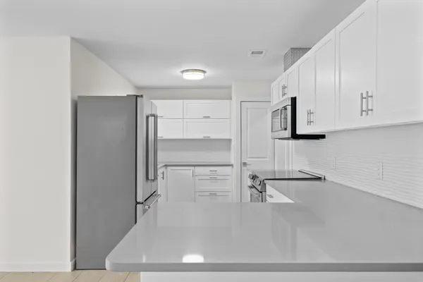 a view white walk in closet with empty racks