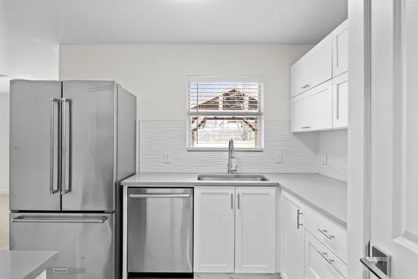 a kitchen with appliances cabinets and a sink