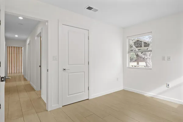 an empty room with windows and closet