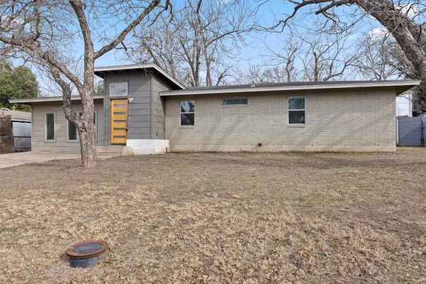 a house that has a tree in front of it