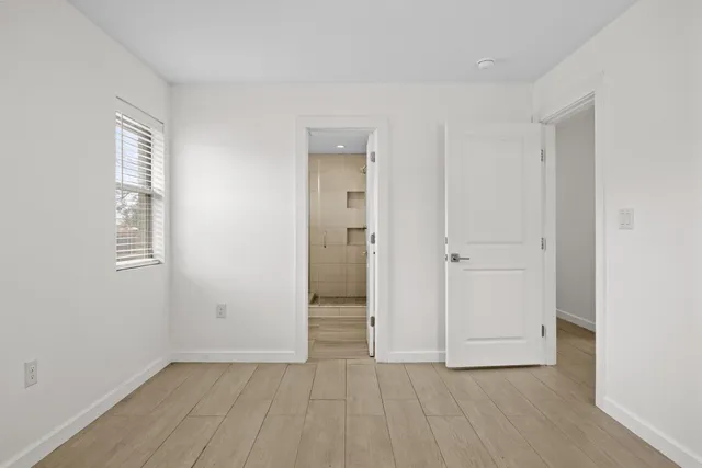 an empty room with windows and closet