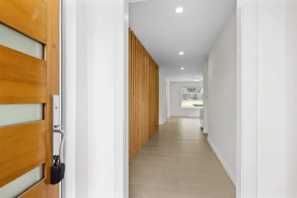 a view of hallway with wooden floor