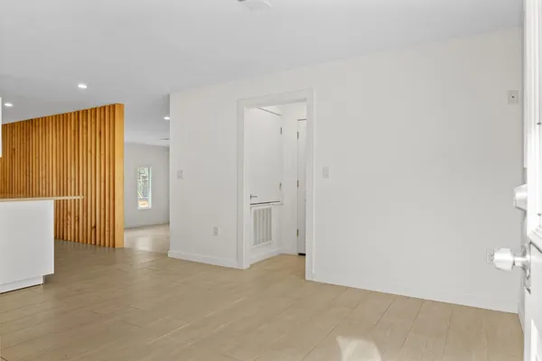 an empty room with a cabinet and mirrors