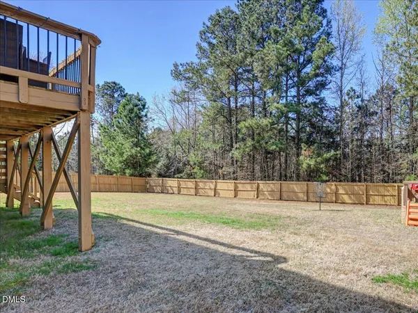 a view of outdoor space with deck and trees
