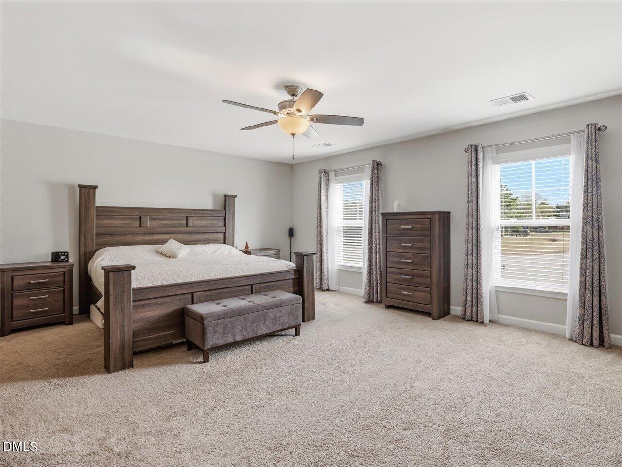 1200 Kinleywood Court Raleigh, NC 27603 - Photo 19 of 30 a bedroom with a bed and a chandelier