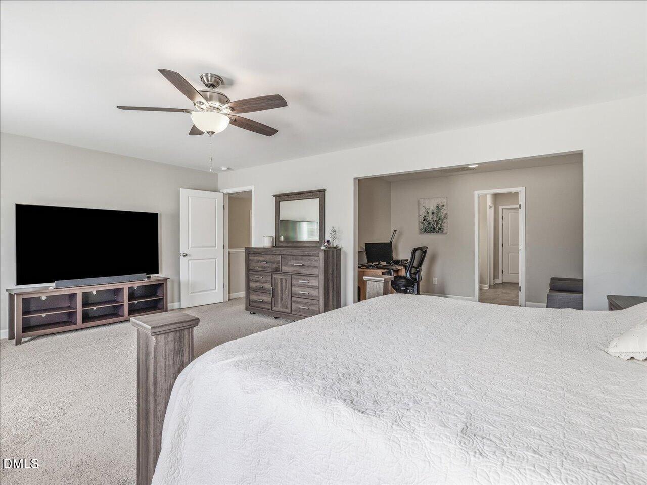 1200 Kinleywood Court Raleigh, NC 27603 - Photo 20 of 30 a bedroom with a bed and a flat screen tv