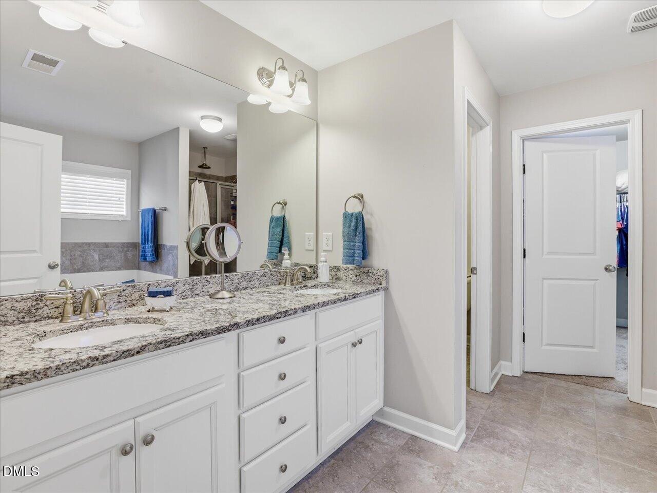 1200 Kinleywood Court Raleigh, NC 27603 - Photo 22 of 30 a bathroom with a granite countertop sink double and mirror