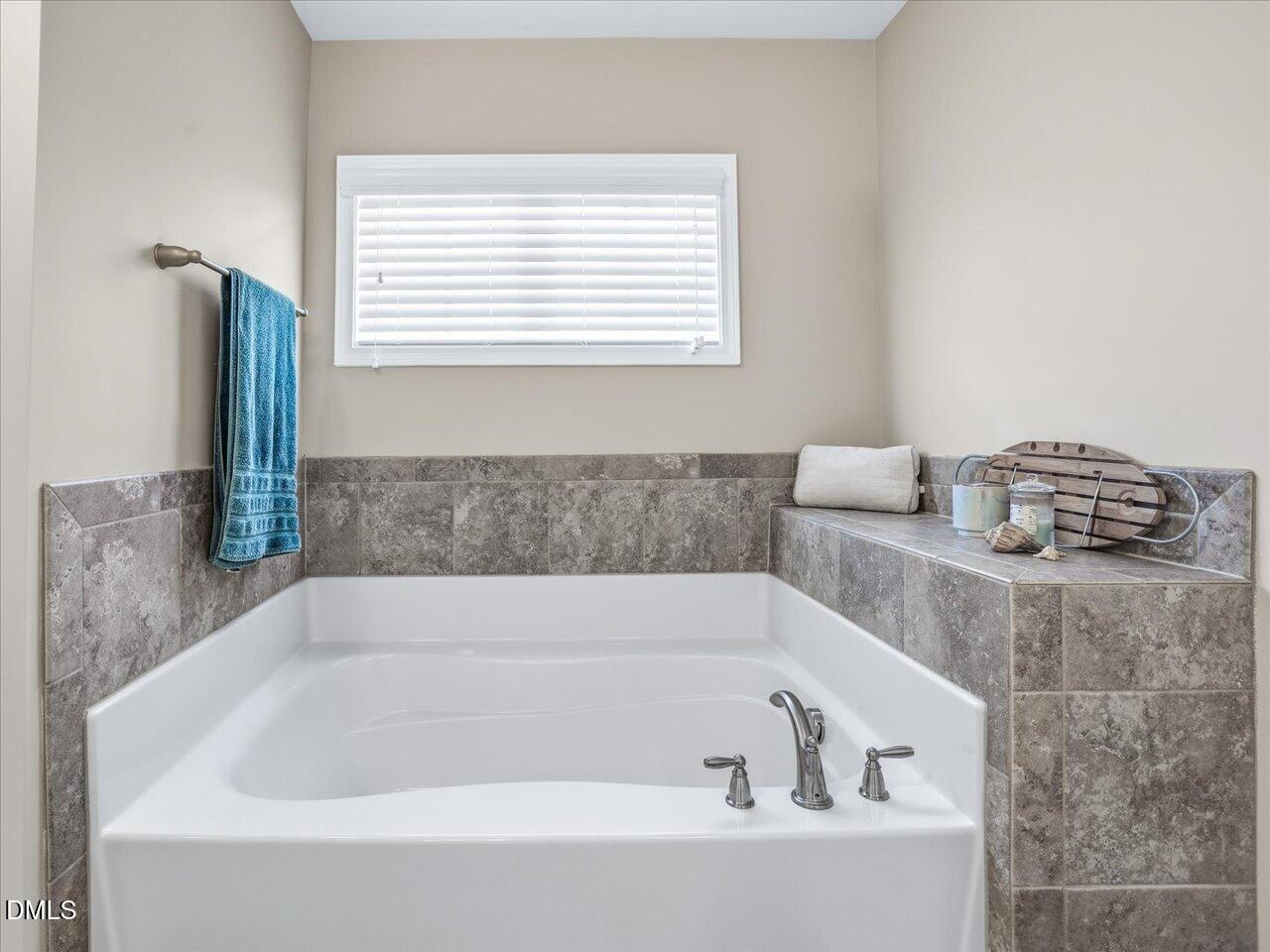1200 Kinleywood Court Raleigh, NC 27603 - Photo 23 of 30 a bathroom with bathtub and window