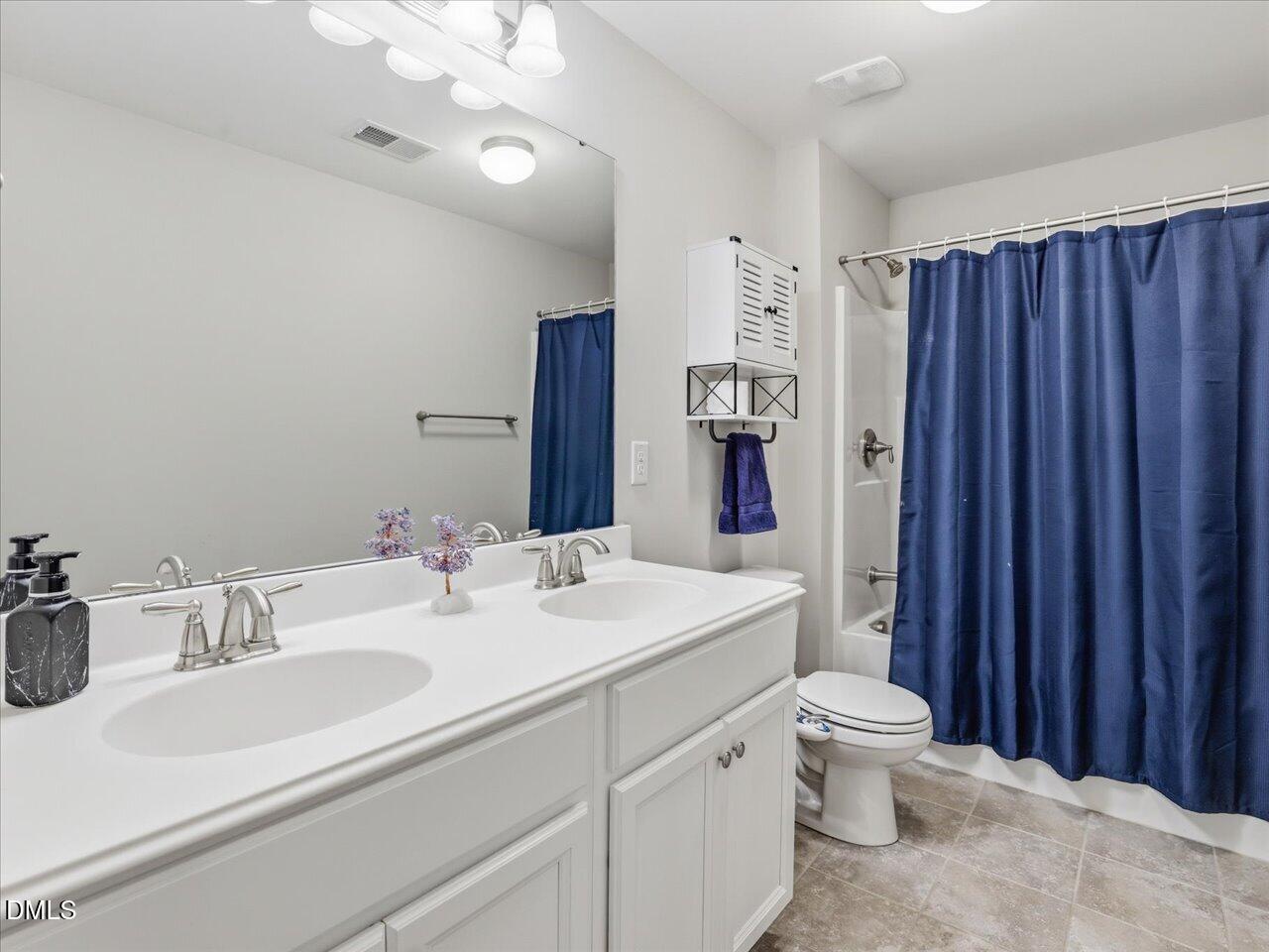 1200 Kinleywood Court Raleigh, NC 27603 - Photo 25 of 30 a bathroom with a sink toilet and shower