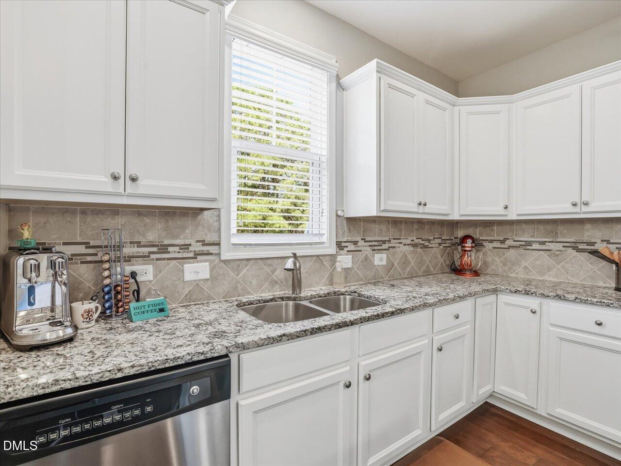 1200 Kinleywood Court Raleigh, NC 27603 - Photo 6 of 30 a kitchen with granite countertop white cabinets and white appliances