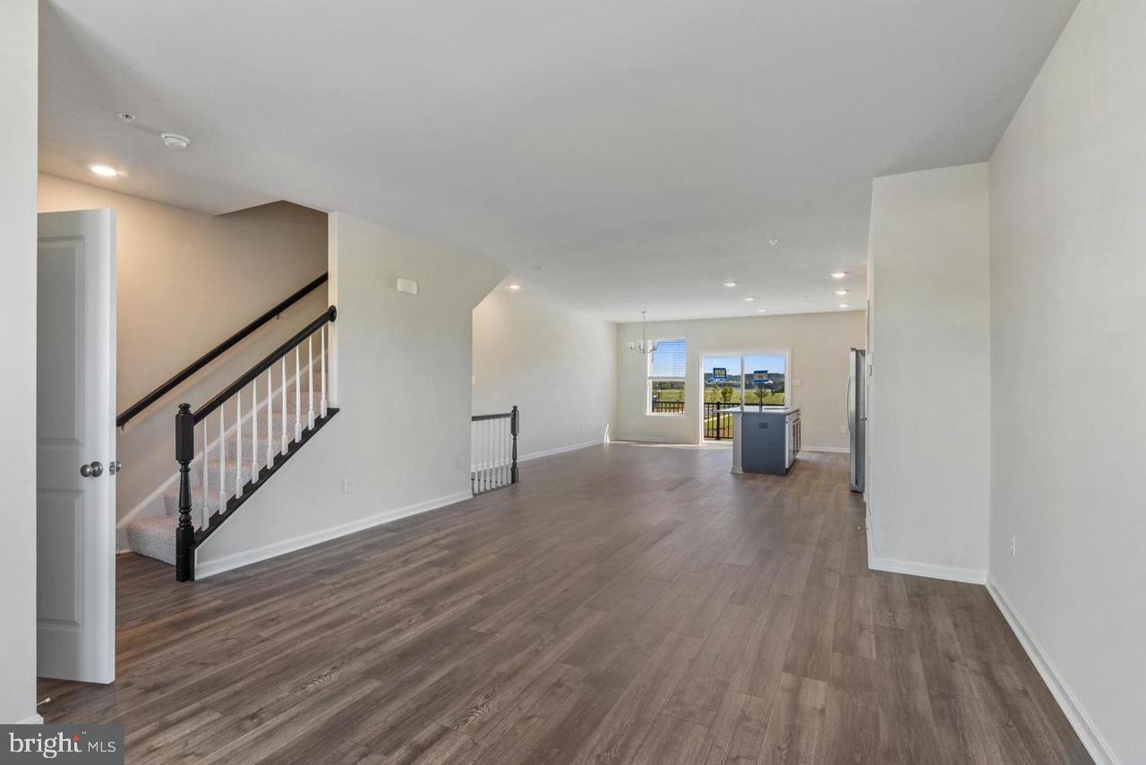 552 Union Street Frederick, MD 21701 - Photo 11 of 58 a view of a hallway with wooden floor fireplace and windows
