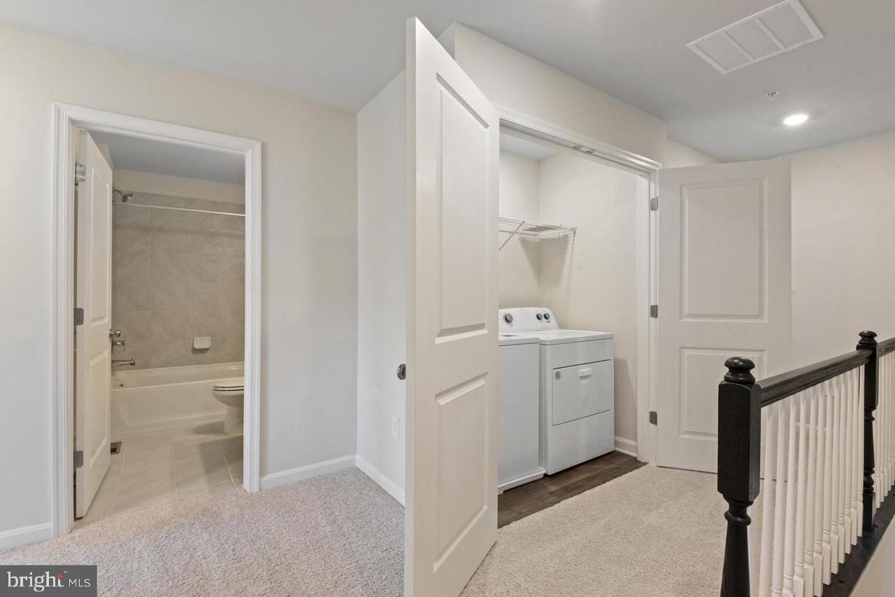 552 Union Street Frederick, MD 21701 - Photo 24 of 58 a view of a hallway with closet and wooden floor