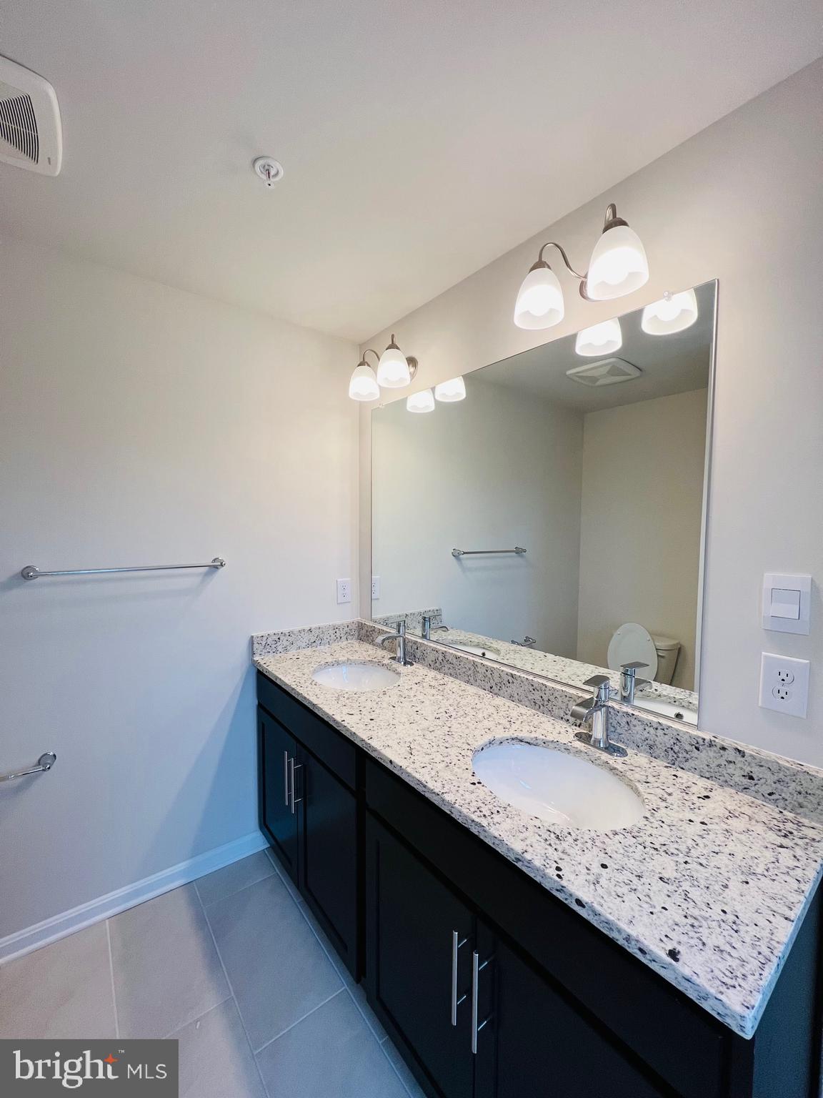 552 Union Street Frederick, MD 21701 - Photo 31 of 58 a bathroom with a granite countertop sink and a mirror