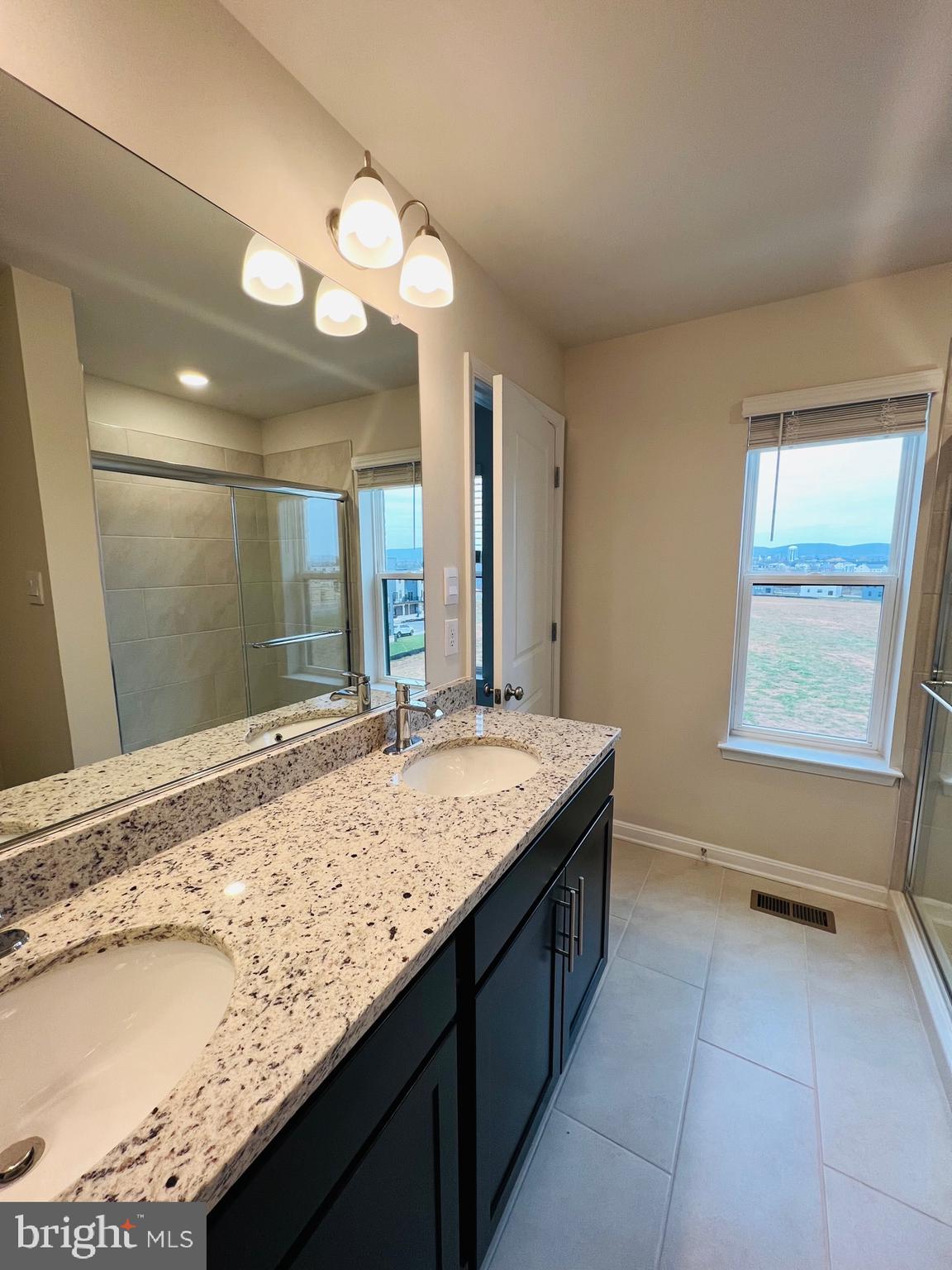 552 Union Street Frederick, MD 21701 - Photo 33 of 58 a bathroom with a granite countertop sink and a mirror