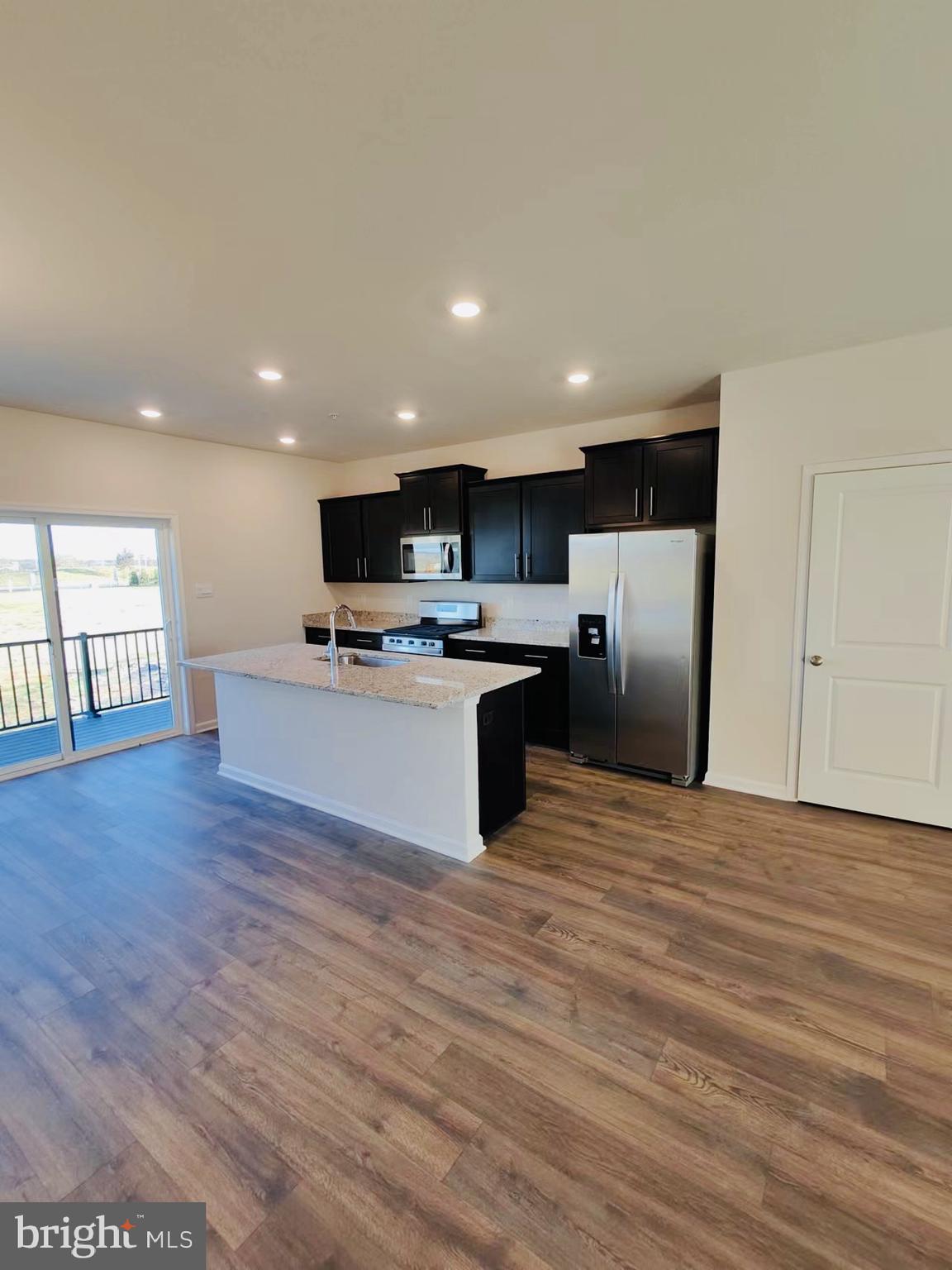 552 Union Street Frederick, MD 21701 - Photo 10 of 58 a large kitchen with stainless steel appliances granite countertop a stove a sink dishwasher and a refrigerator with wooden floor