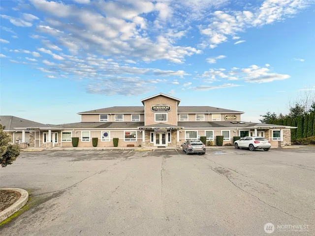 a city view with tall buildings and cars parked in front of it
