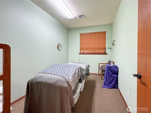 a bedroom with a bed and a couch