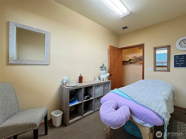 a bedroom with a bed and a bookshelf