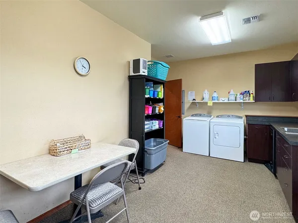 a kitchen with a sink cabinets and appliances