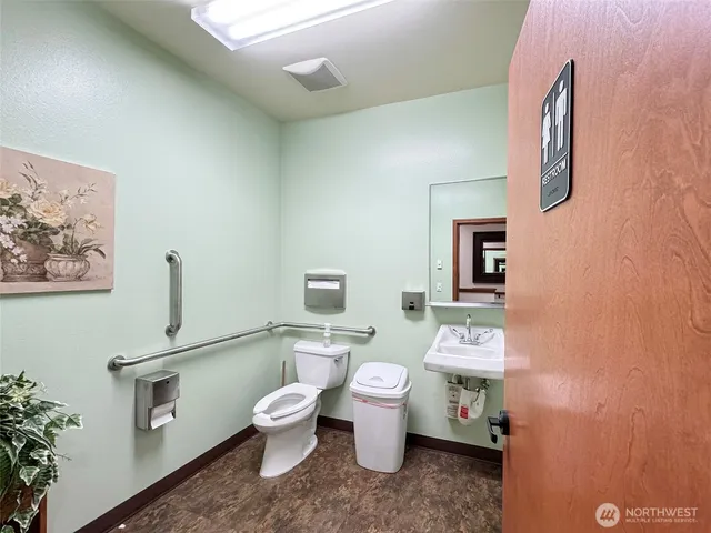 a white toilet sitting next to a bathroom sink