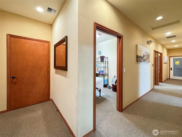 a view of a hallway with closet and a livingroom view
