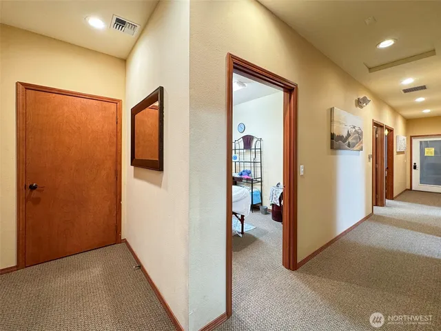 a view of a hallway with closet and a livingroom view