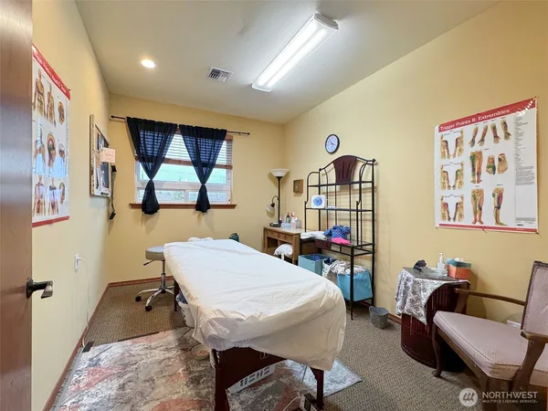 a room with furniture pool table and window