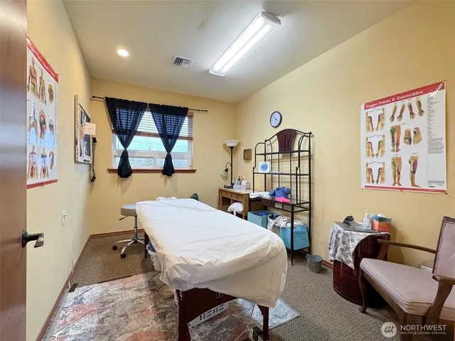 a room with furniture pool table and window