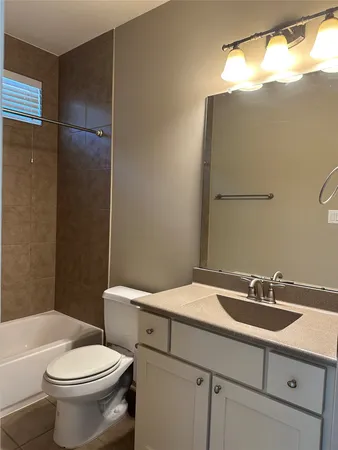 a bathroom with a toilet and a bath tub