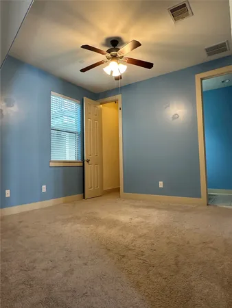 a bathroom with a granite countertop sink toilet and mirror