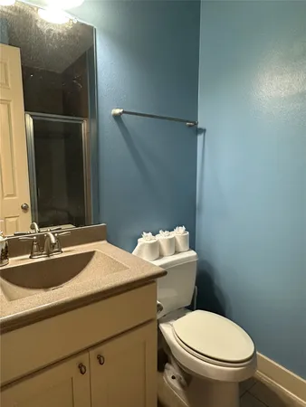 a bathroom with a glass shower door
