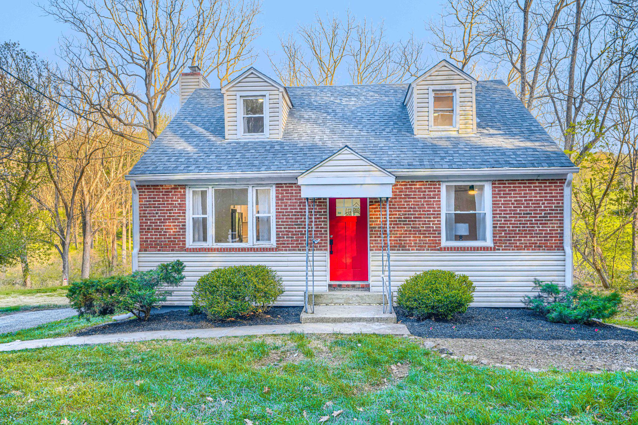 a front view of a house with a yard and porch