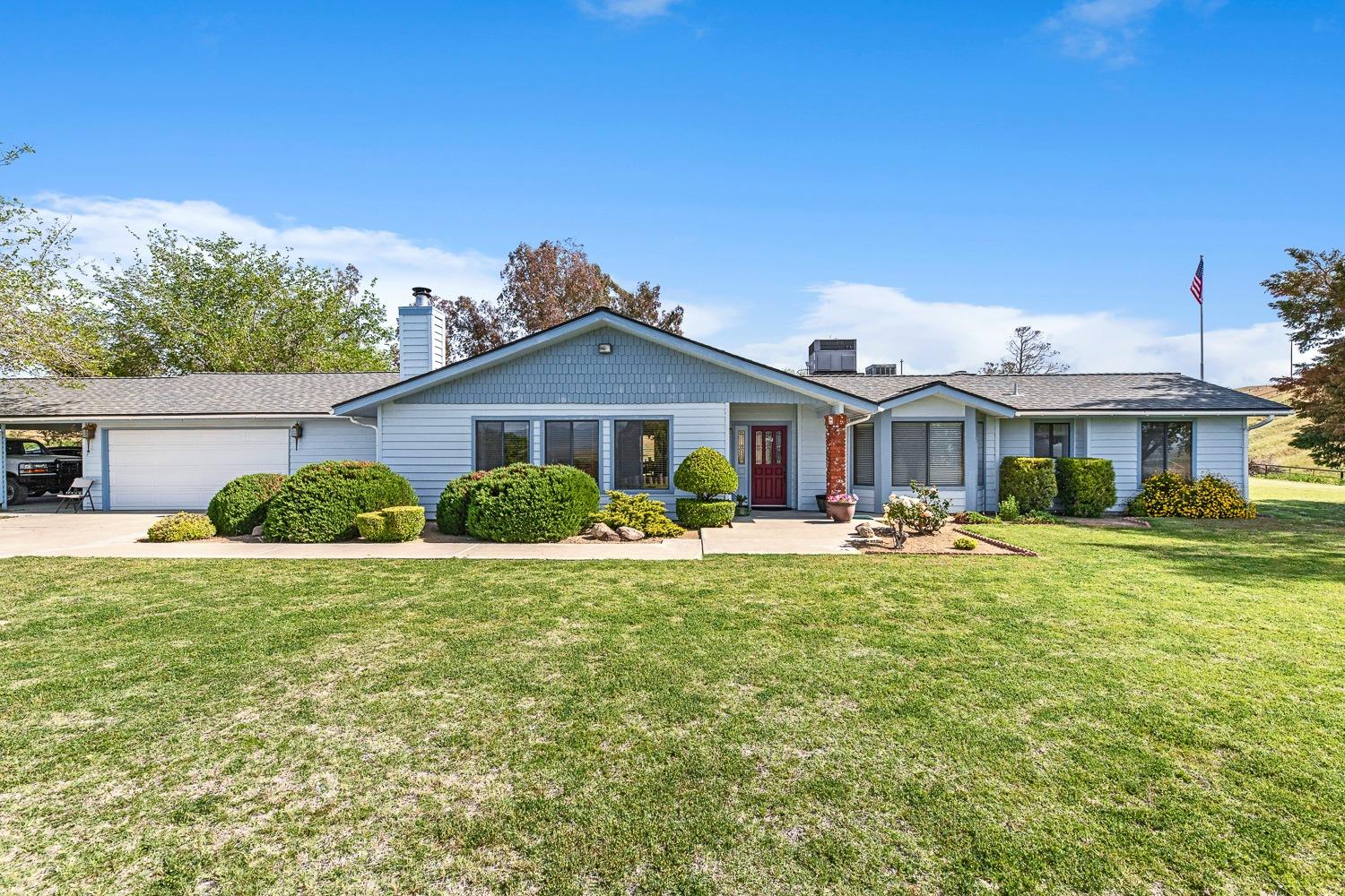 a front view of a house with swimming pool having outdoor seating