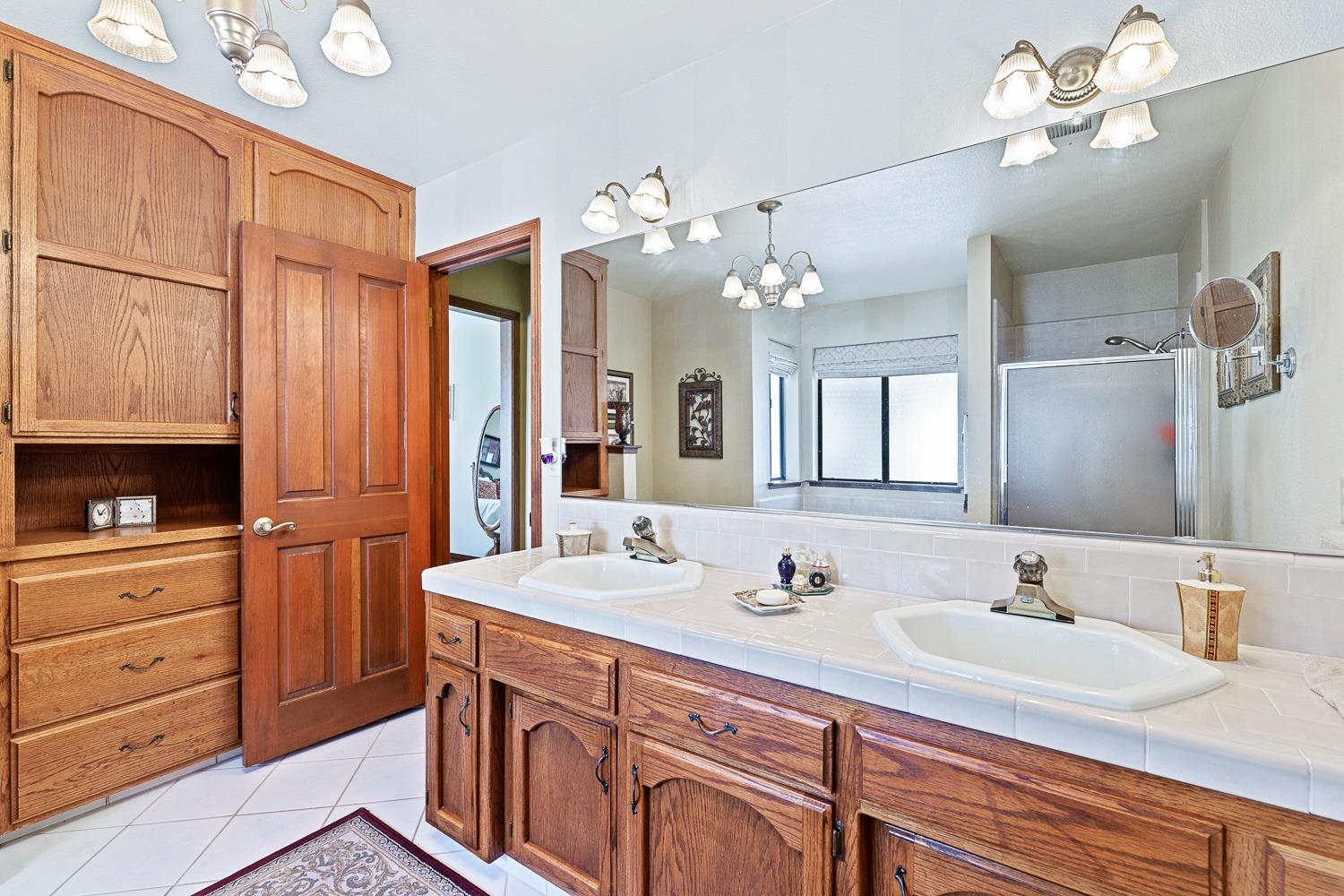 36360 Highway 33 Coalinga, CA 93210 - Photo 20 of 50 a bathroom with a sink double vanity granite tub and a mirror