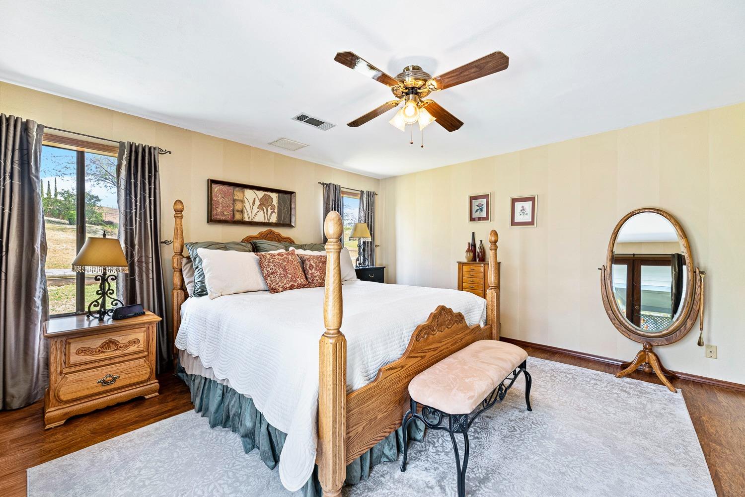 36360 Highway 33 Coalinga, CA 93210 - Photo 22 of 50 a bedroom with a bed and a mirror on the dresser