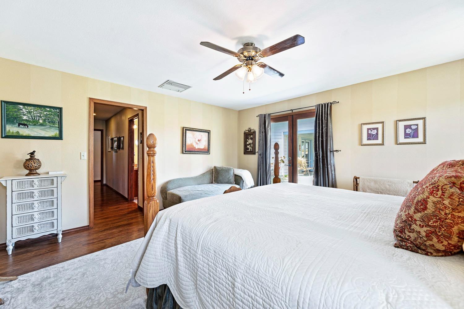 36360 Highway 33 Coalinga, CA 93210 - Photo 23 of 50 a bedroom with a bed and a chandelier