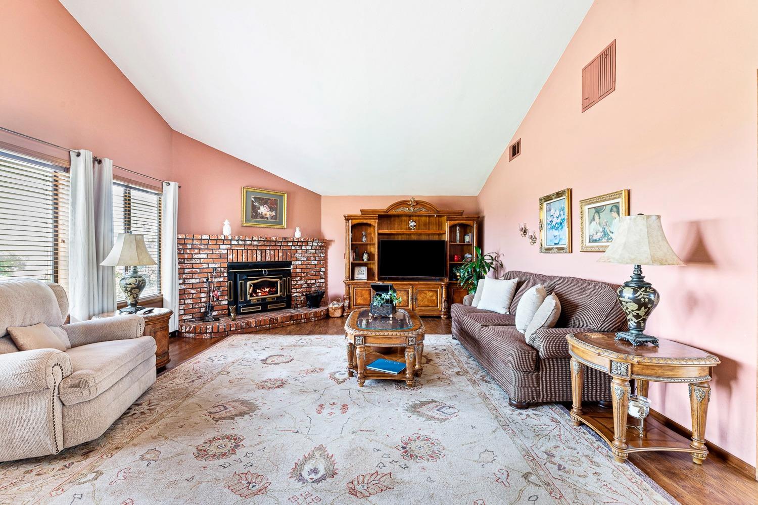36360 Highway 33 Coalinga, CA 93210 - Photo 25 of 50 a living room with furniture a fireplace and a flat screen tv